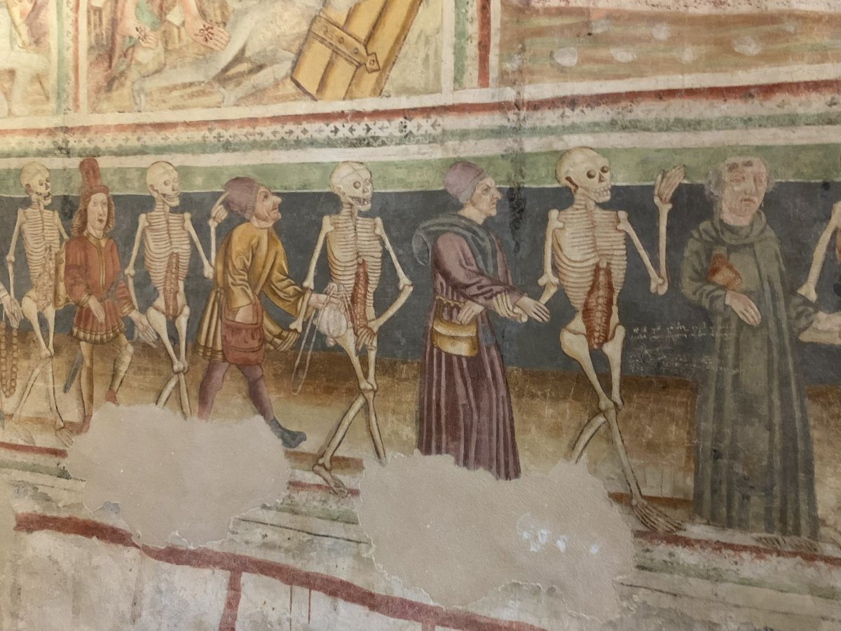 Everyone is equal in death is the message and here Death is waving away the attempts of a rich man to cheat him or her..