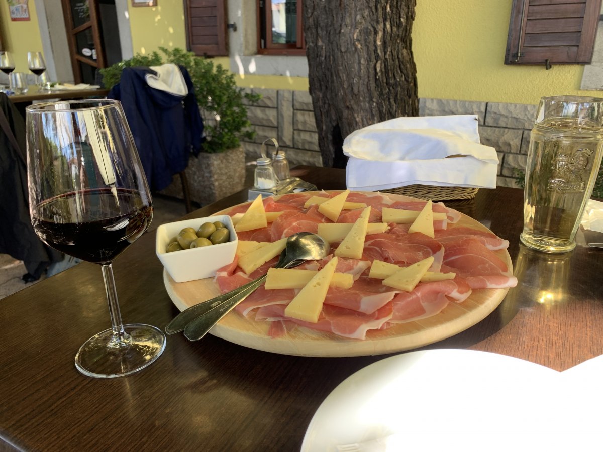 a Red Karst restaurant Tapas accompanied by a glass of blood red local Teran wine..