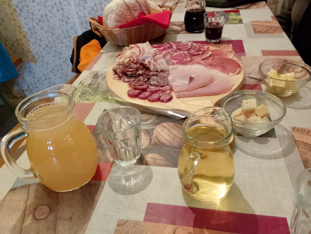 a typical Red Karst Tapas board with Teran wine and freshly squeezed apple juice..