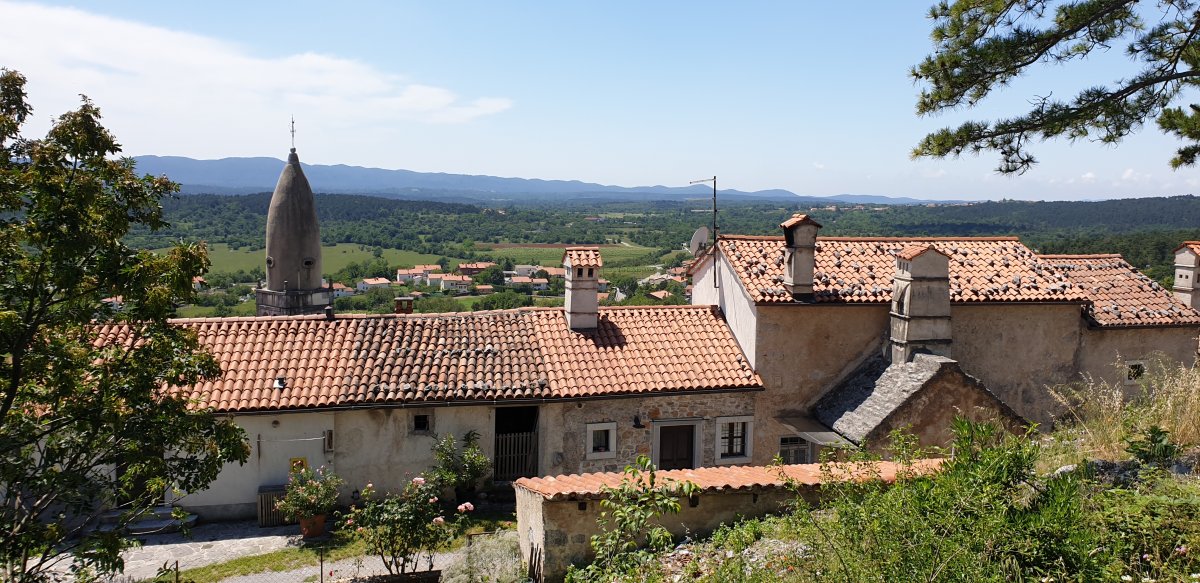 Terracotta rooftop view across the Red Karst, which is also greener than you might think..