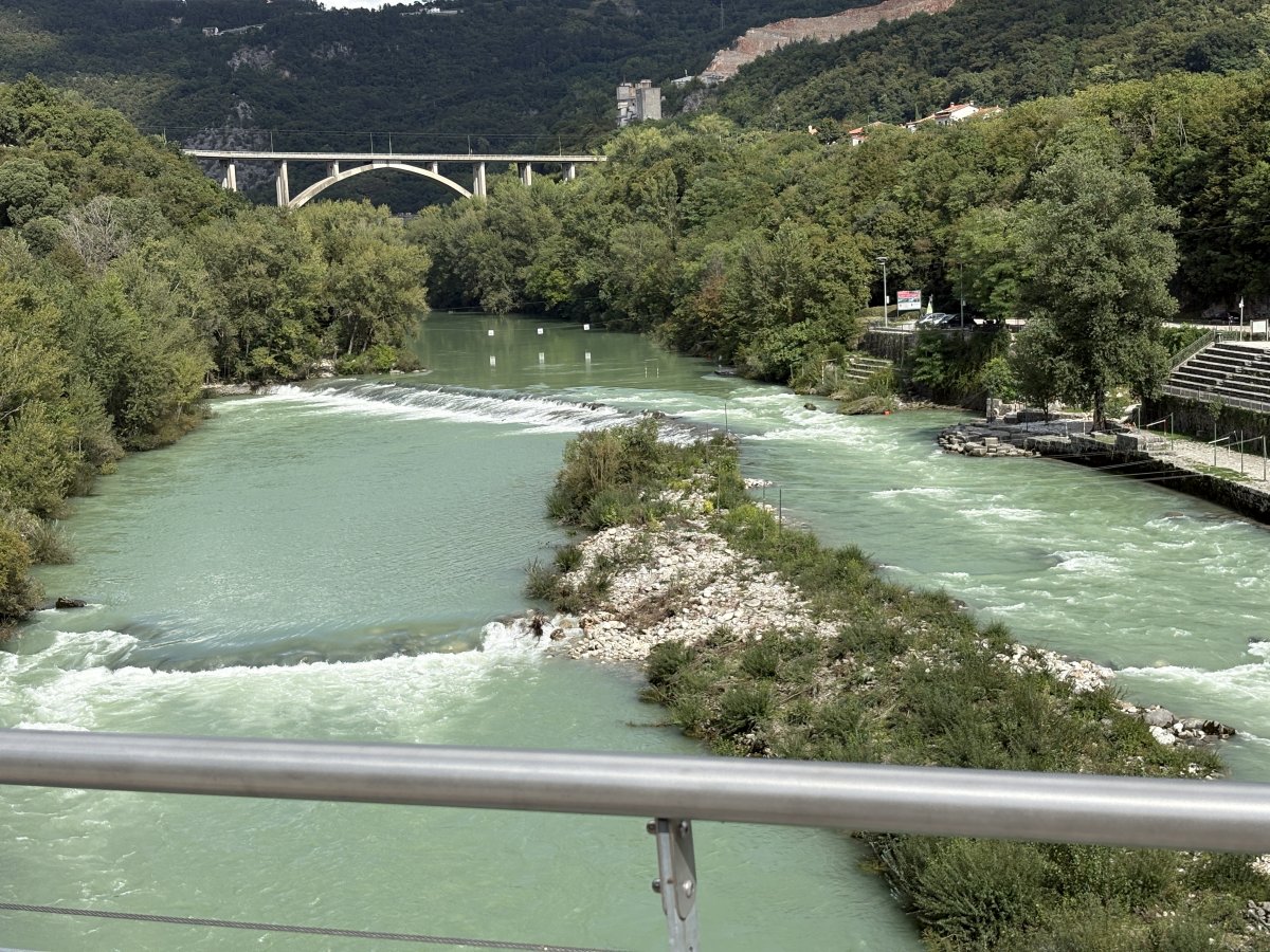 Stunning view from the Bike bridge up the Soča river and Kayak centre to the Solkan railway bridge.. Stunning view from the Bike bridge up the Soča river and Kayak centre to the Solkan railway bridge..