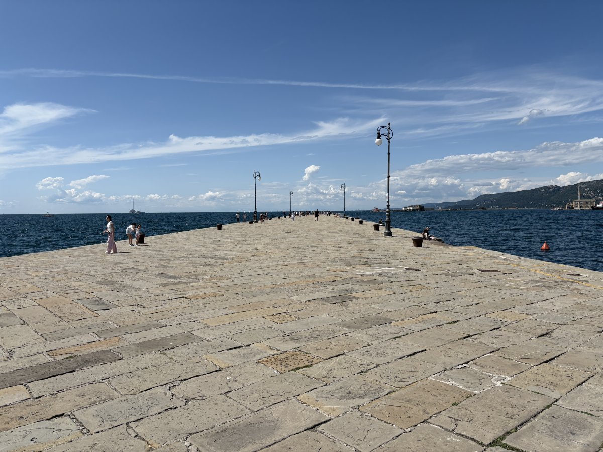 Trieste.. Huge stone pier leads out into the sea.. Miramare Castello is in the distance..